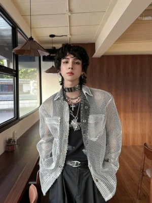 Full front view of a men's oversized sheer honeycomb mesh shirt layered over black clothing with necklaces and a choker for Seoul streetwear styling