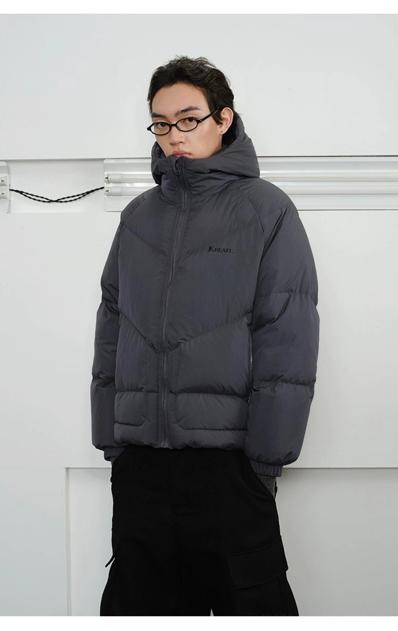 Side front view of men's slate grey down puffer jacket featuring streamlined chevron panel quilting and relaxed streetwear silhouette