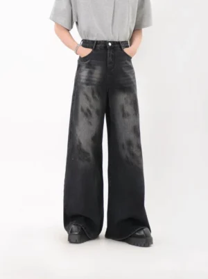 Front full body view of mens storm fade washed black wide leg denim jeans with high rise waist and pooled hem
