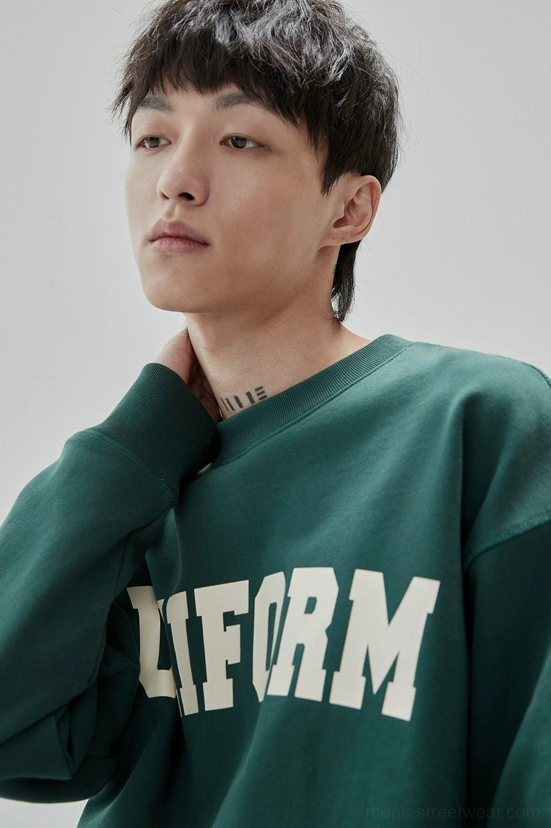 Relaxed men's streetwear sweatshirt with bold UNIFORM lettering and vintage rubber print