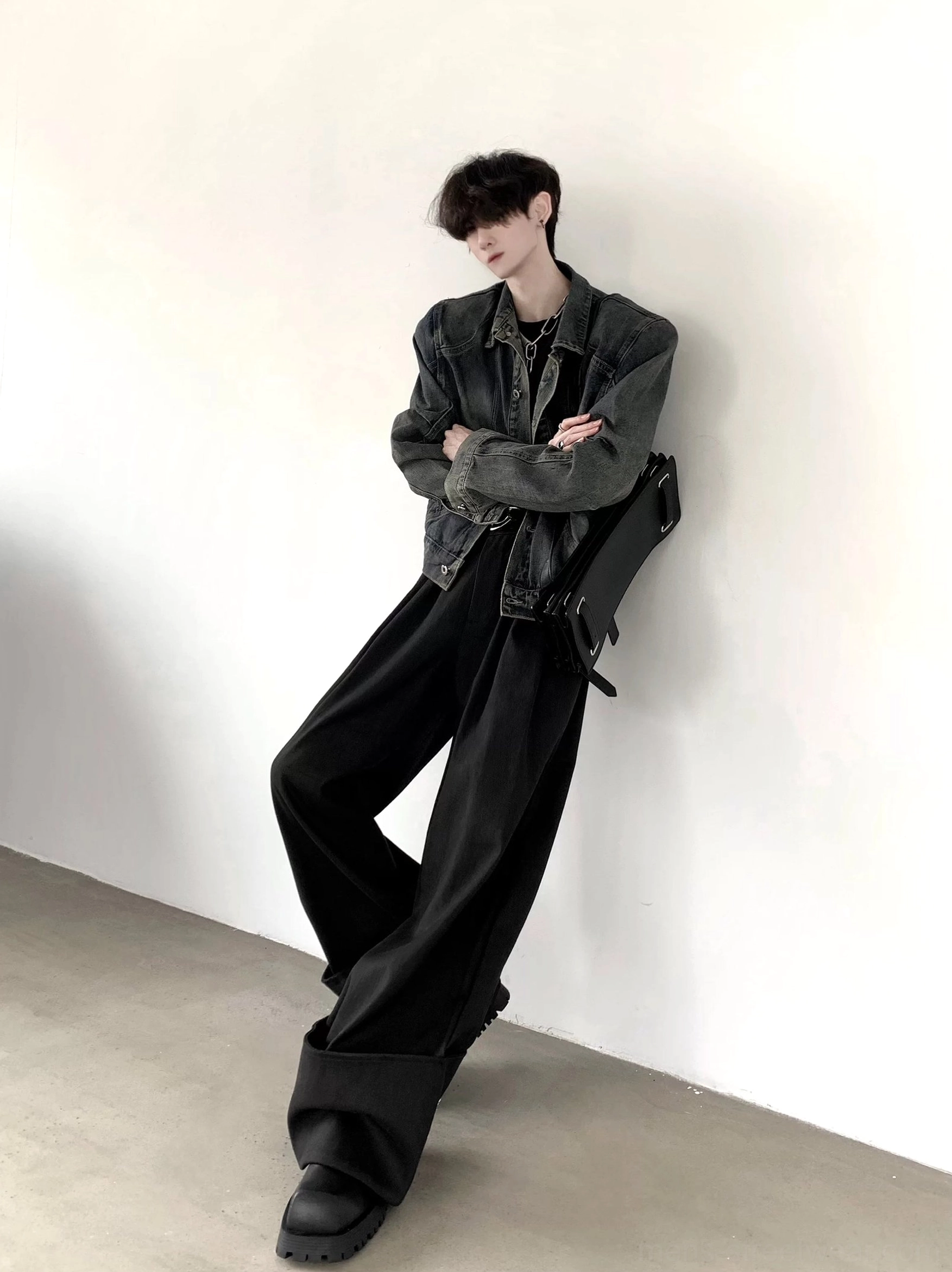 Side view of men's structured vintage wash denim jacket with curved seam detailing in minimalist Korean streetwear styling