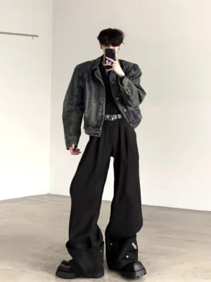 Men's cropped boxy washed blue denim jacket with structured shoulders styled with black wide-leg trousers in a mirror selfie