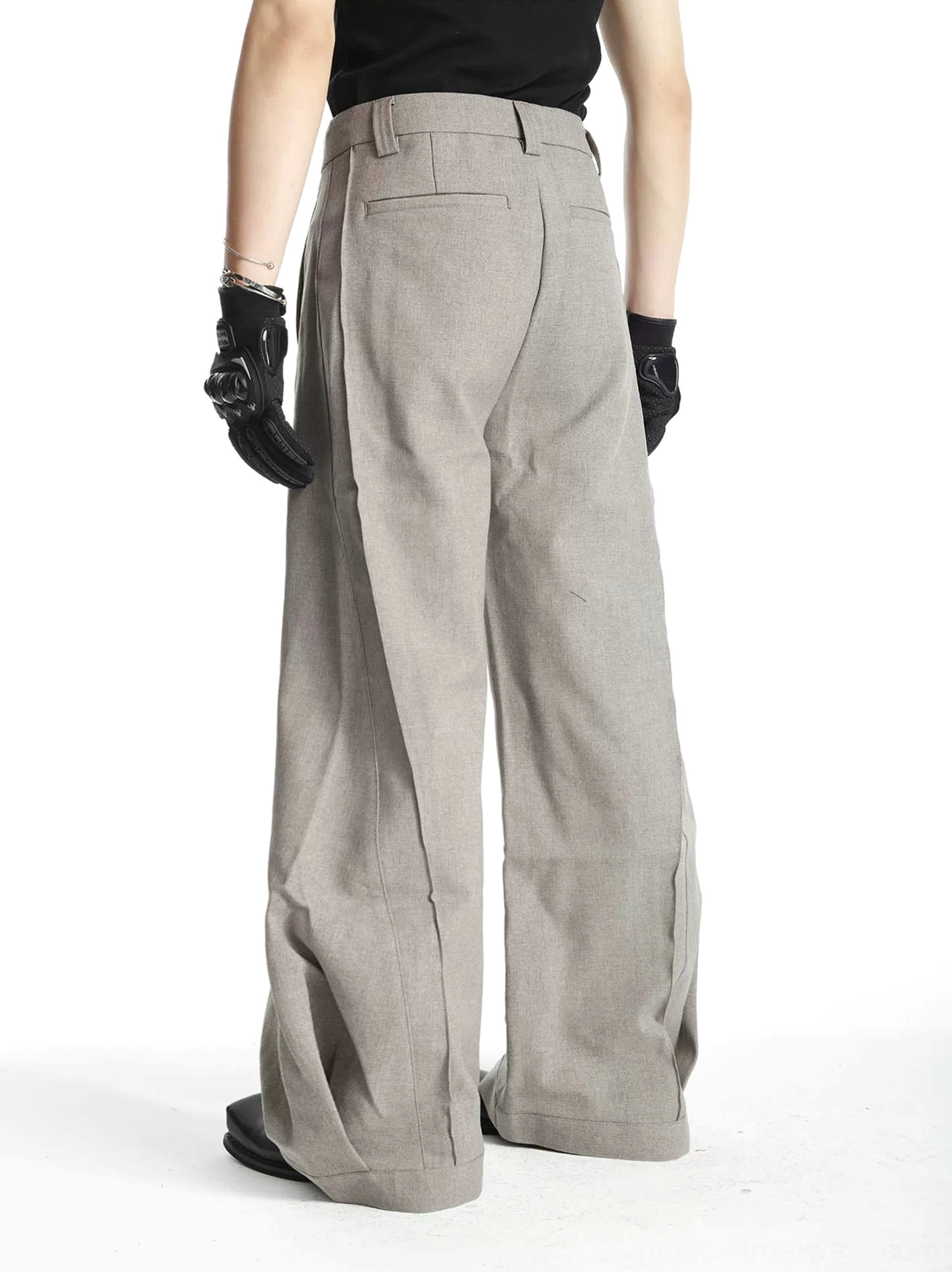 Rear view of men's heather gray barrel-leg suit trousers showing rear pockets belt loops and wide draped leg silhouette