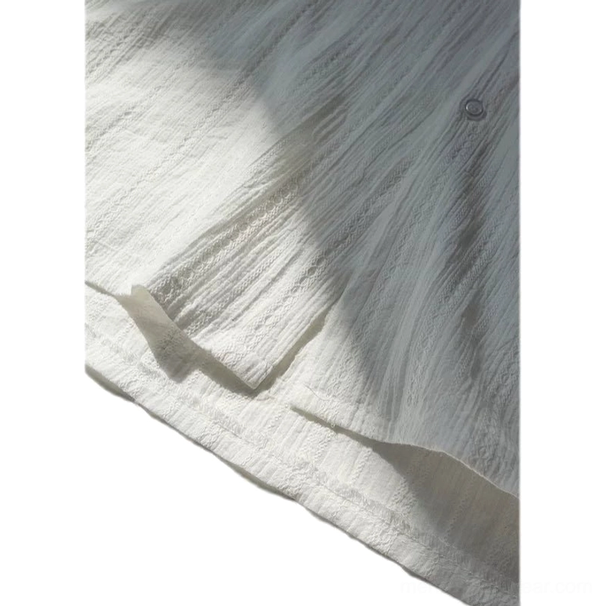 Close-up view of vertical wrinkled stripe texture, round buttons, and soft surface detail on men's streetwear shirt