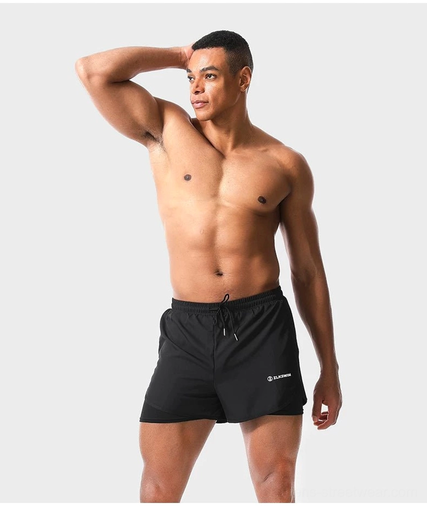 Black men's twin-layer swim shorts styled for beach and pool wear with lightweight quick-dry outer shell