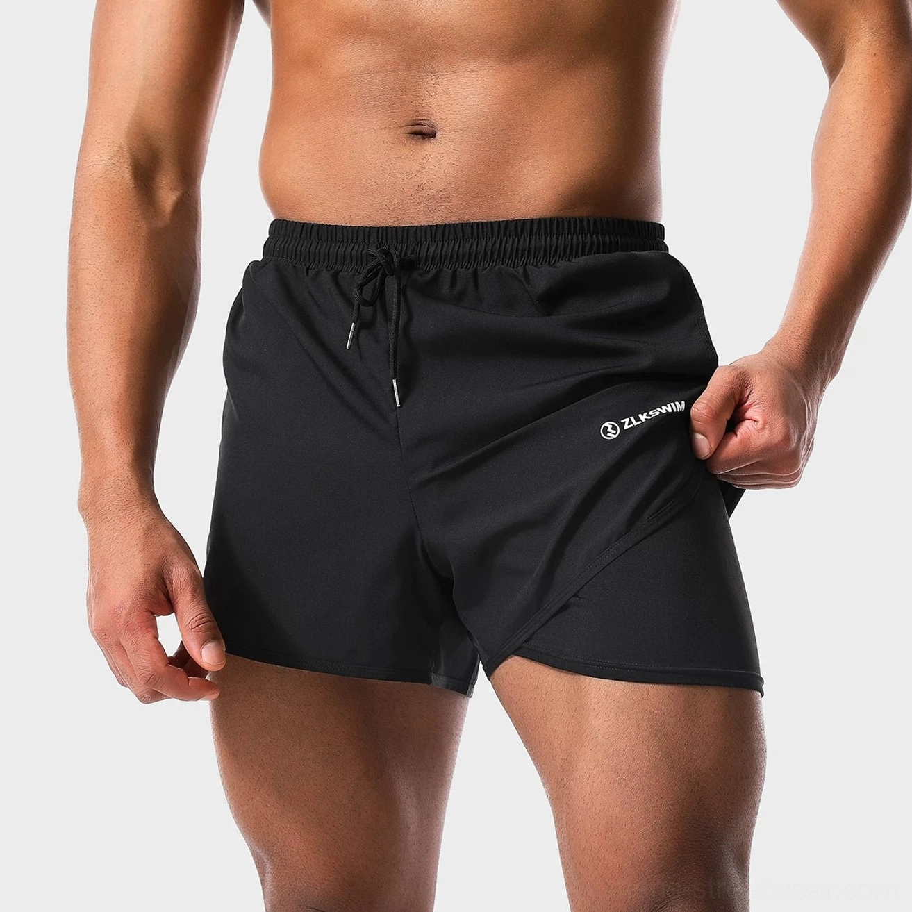 Black men's quick-dry twin-layer swim shorts close-up with drawstring elastic waist and built-in liner