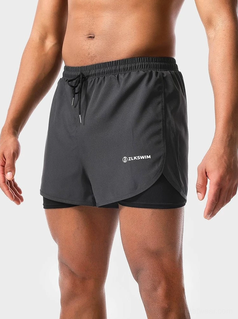 Dark gray men's double-layer quick-dry swim shorts with curved athletic hem and inner liner side front view