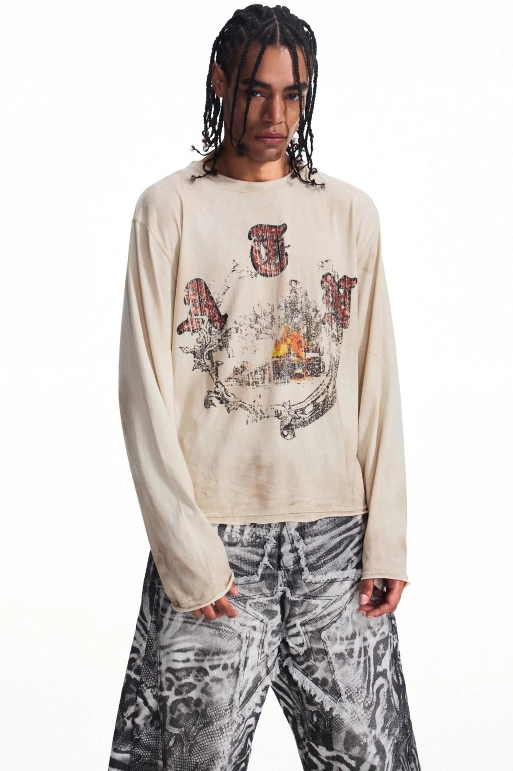 Three-quarter view of men's vintage apricot long sleeve graphic t-shirt styled with wide-leg printed trousers