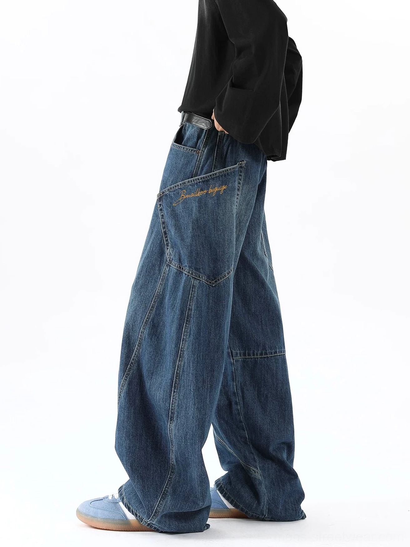 Men's vintage washed blue balloon cargo jeans in left three-quarter view showing ultra-wide curved leg seams and side utility pocket