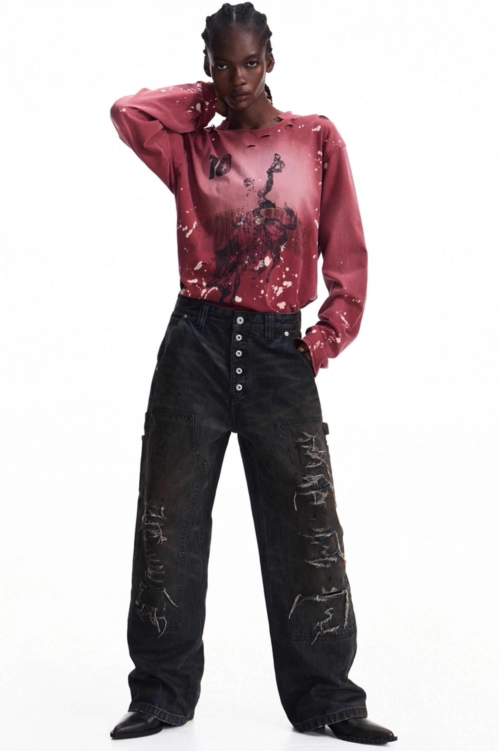 Men's vintage burgundy graphic long-sleeve T-shirt styled with wide-leg cargo jeans, featuring distressed neckline, bold front artwork, ink splatter details, and relaxed sleeves