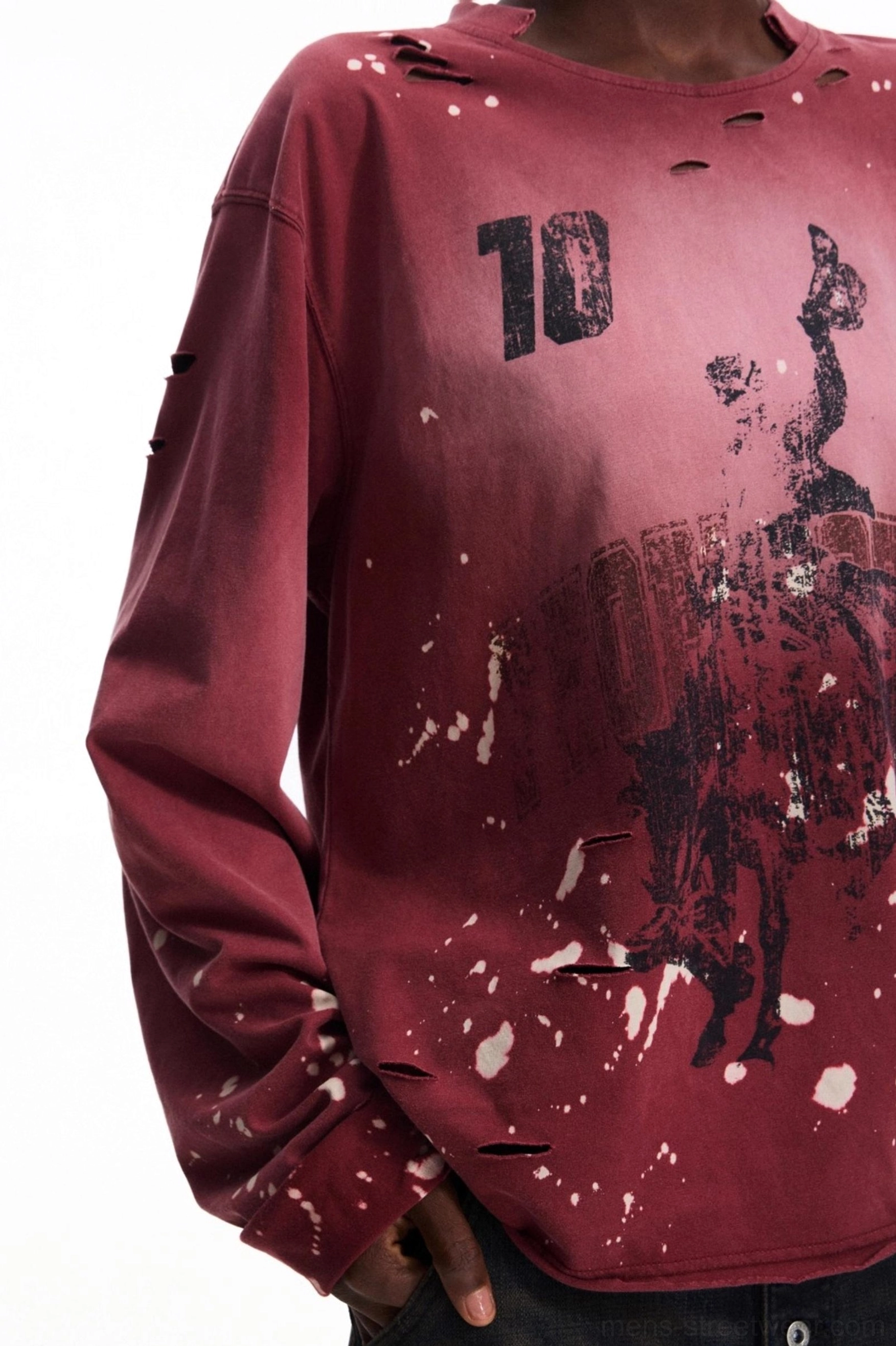 Close-up detail of a men's vintage burgundy graphic long-sleeve T-shirt showing the number 10 print, abstract artwork, white ink splatters, gradient wash, and distressed neckline