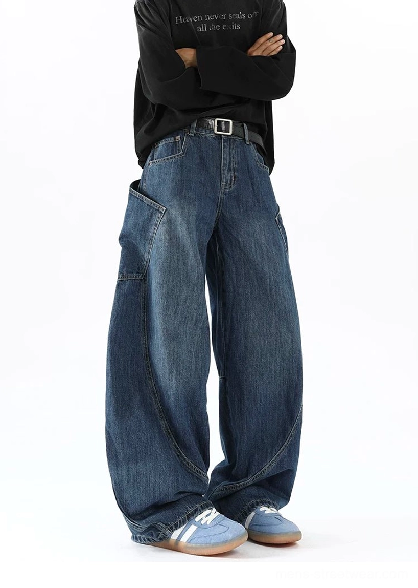 Men's vintage indigo balloon denim jeans right three-quarter full view featuring embroidered cargo pocket curved seams and pooled hems