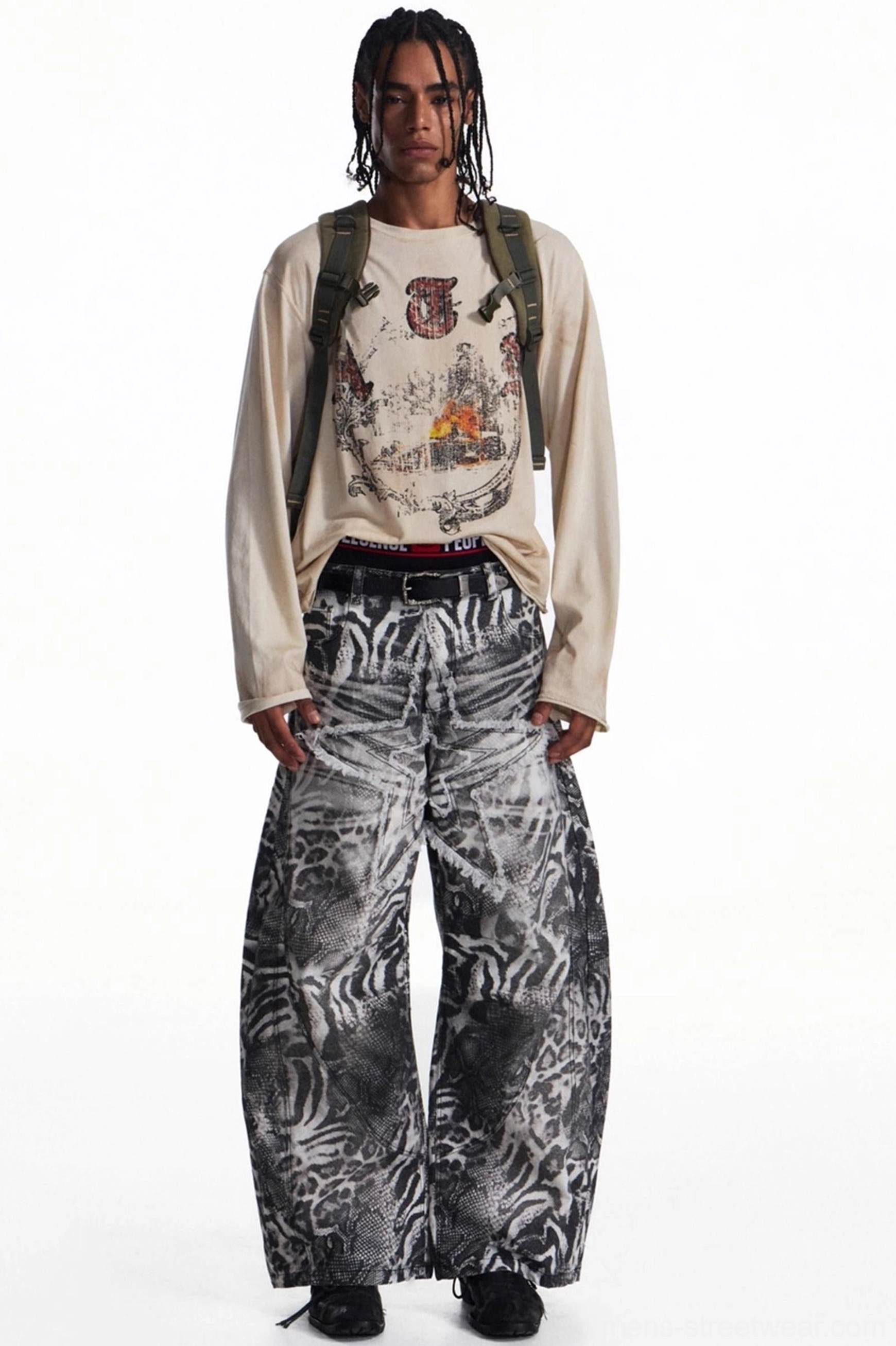 Front outfit view of men's vintage long sleeve graphic streetwear t-shirt with backpack, belt, and wide-leg trousers