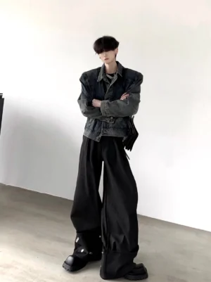 Men's vintage wash structured denim trucker jacket in faded dark indigo shown in a front three-quarter full-body streetwear outfit