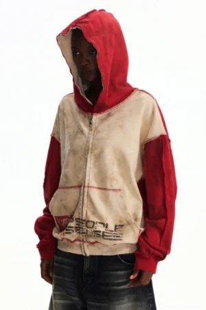 Three-quarter side view of men’s washed two-tone red sleeve graphic zip hooded streetwear jacket