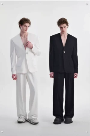 Men's white collarless metallic button blazer with matching wide-leg trousers in minimalist studio