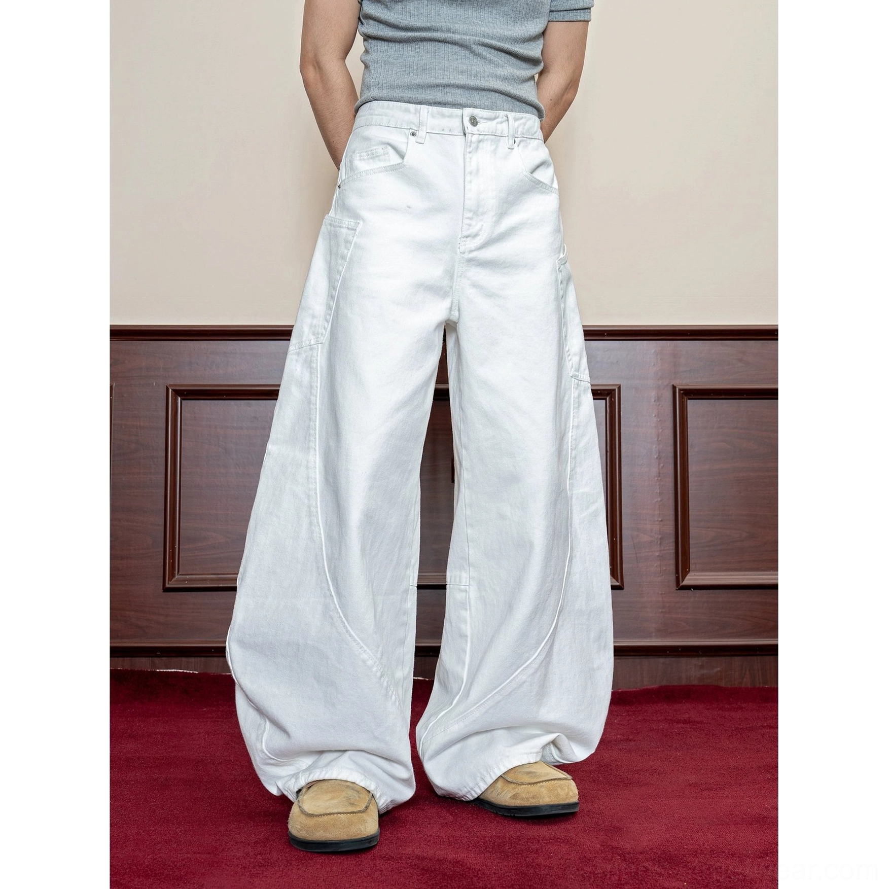 Men's white curved seam baggy wide leg denim jeans full front view with classic waistband and long relaxed silhouette