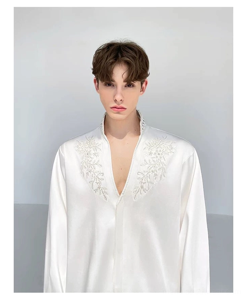 Front view of men's white floral embroidered satin shirt with relaxed long sleeves and a deep V stand collar