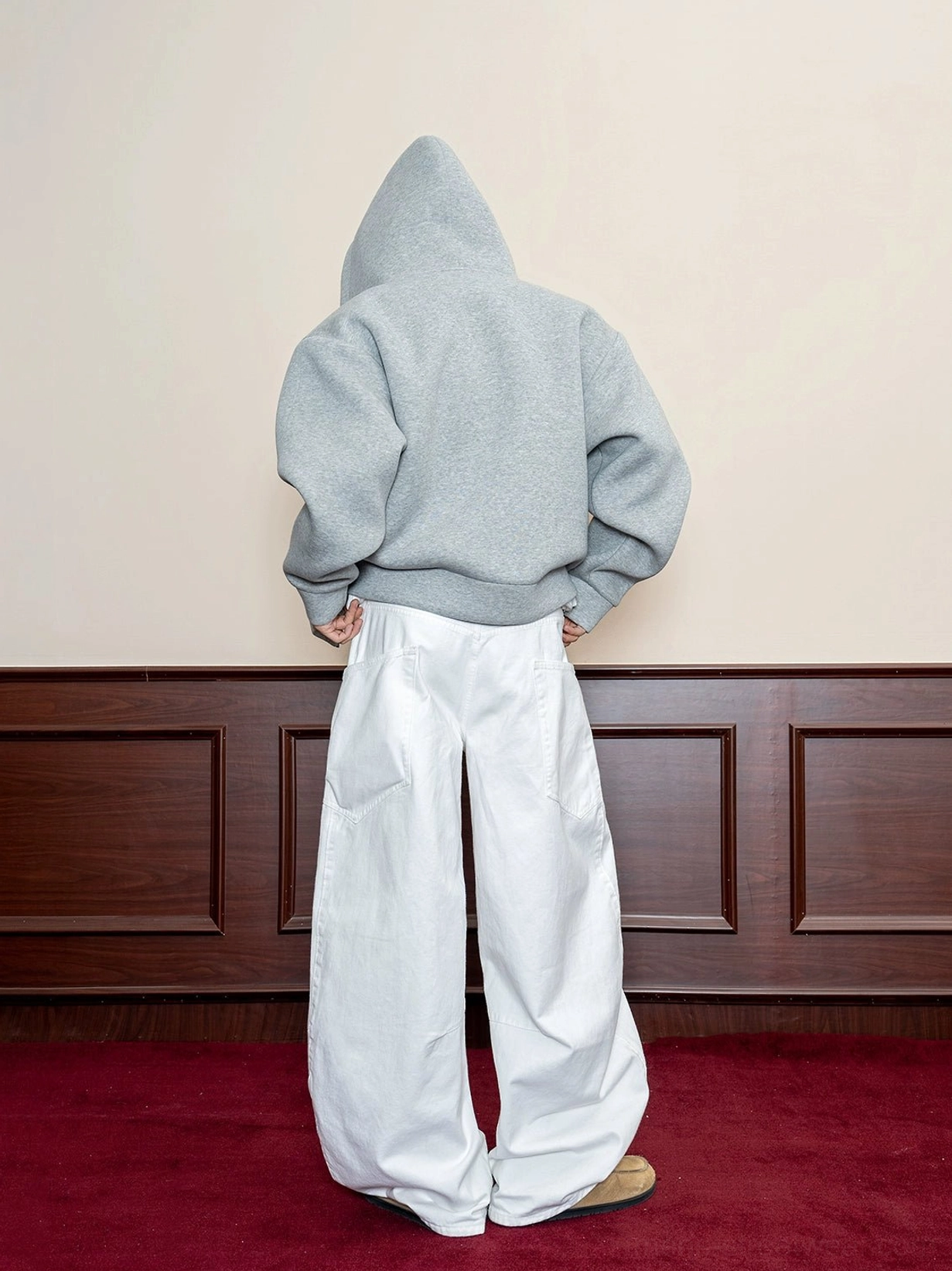 Men's white oversized baggy denim jeans back view showing wide floor-length legs and rear patch pockets
