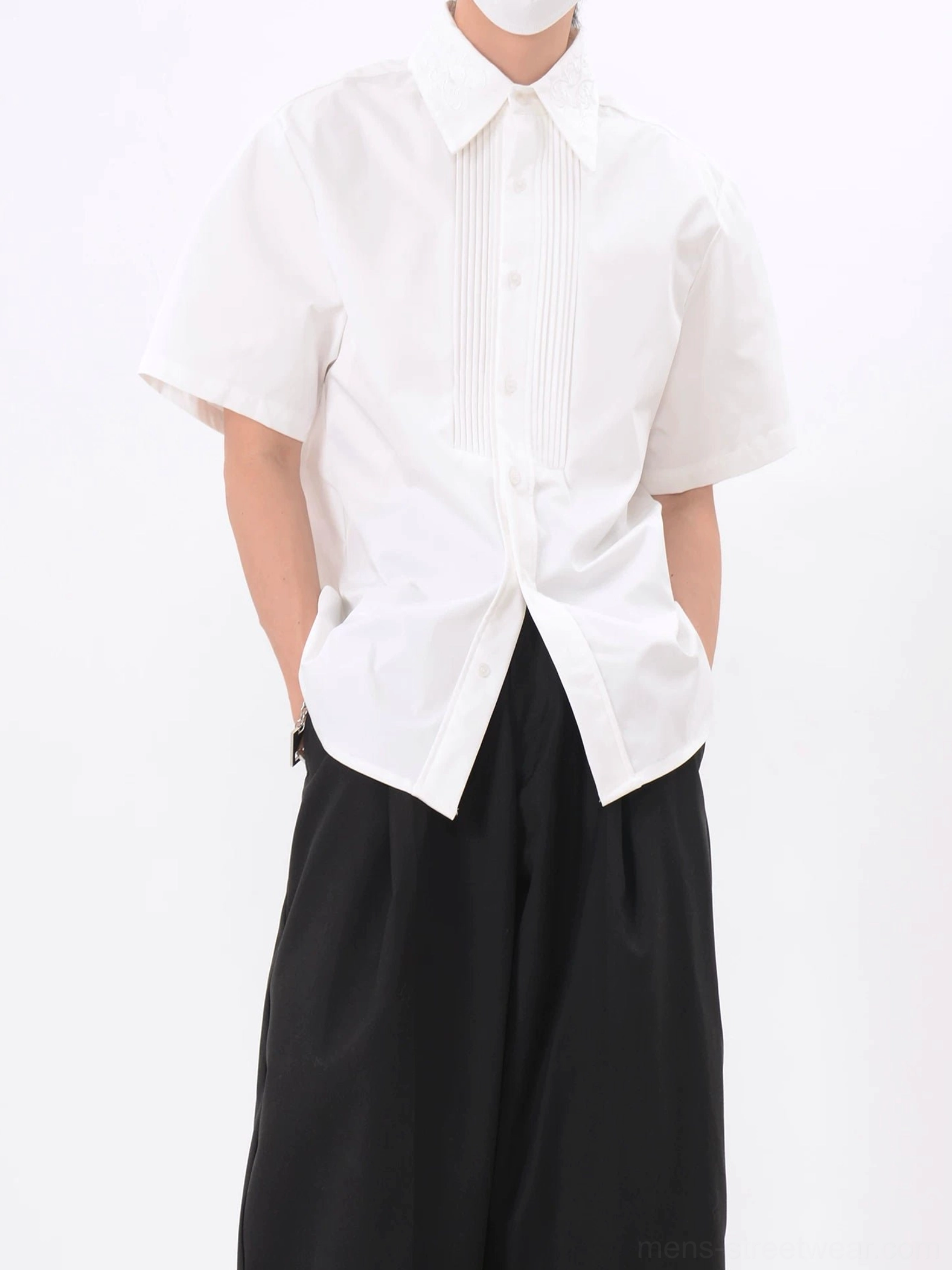 Men's white pleated tuxedo short sleeve shirt paired with black wide leg pants in Korean minimalist fashion outfit