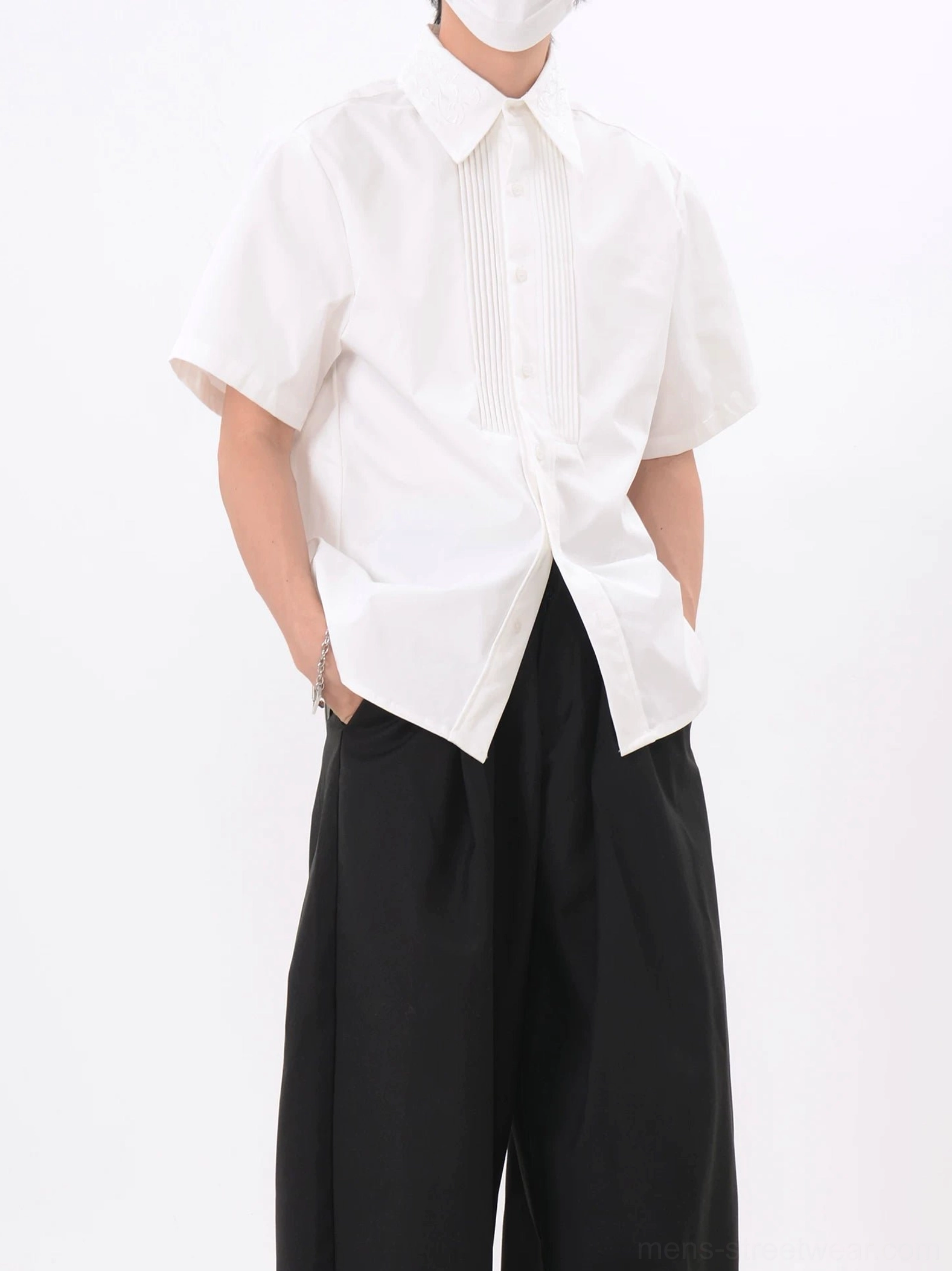 Men's white formal streetwear shirt featuring a tuxedo inspired pleated button placket and relaxed silhouette