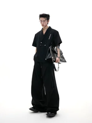 Black metal embellished Korean streetwear sports suit with shawl collar short sleeve top and wide-leg trousers shown from the front three-quarter view