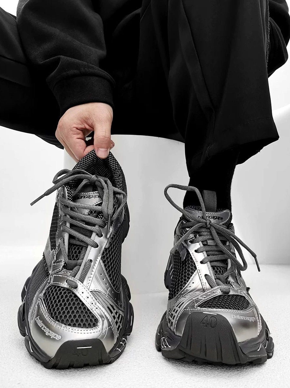 Silver and black metallic chunky mesh sneakers shown from an overhead front angle with reflective toe cap, breathable vamp, and rugged 4cm streetwear sole