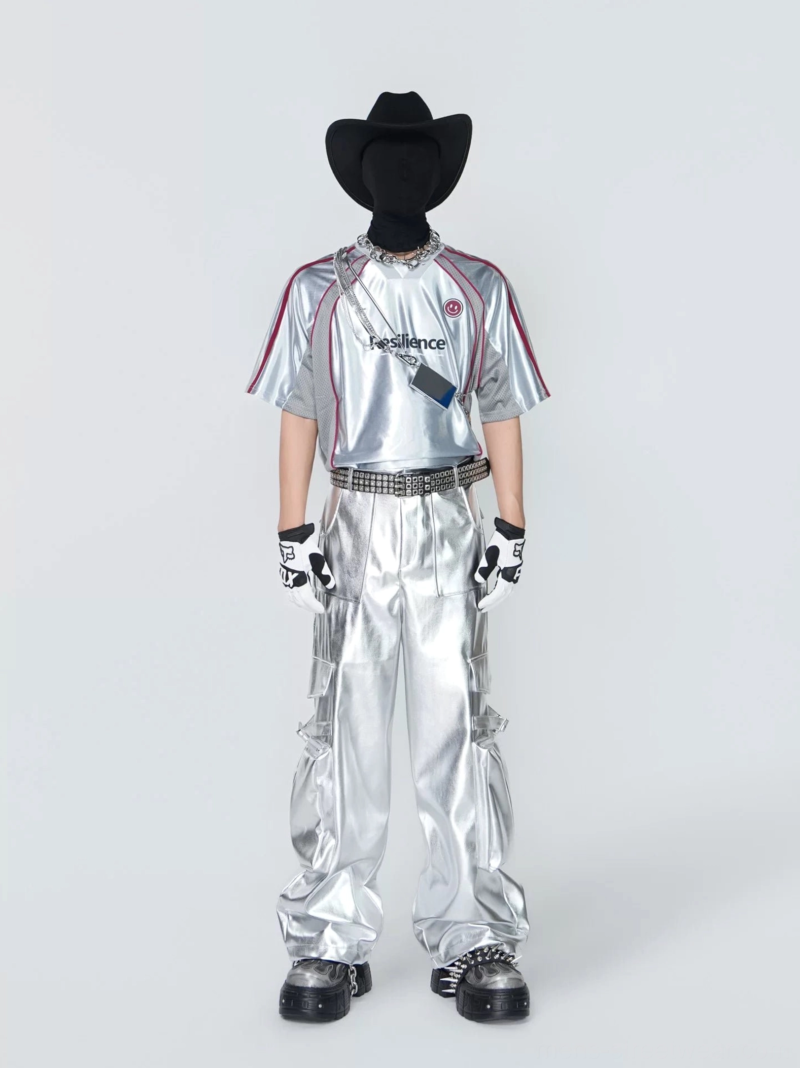 Front full-body view of a metallic silver Resilience tech jersey top with red racing stripes, relaxed athletic fit, and futuristic streetwear styling
