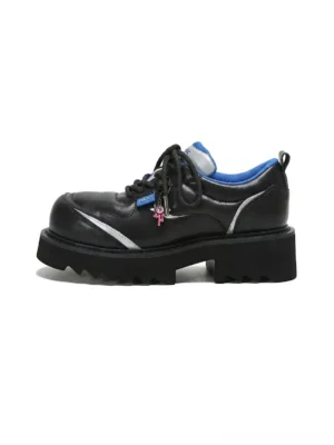 Black metallic stardust chunky lug sole derby shoe with silver side panel and decorative lace pendant front side view
