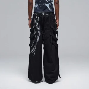 Back view of oversized black metallic strap cargo pants showing adjustable drawstring waist, rear strap details, and relaxed wide-leg silhouette