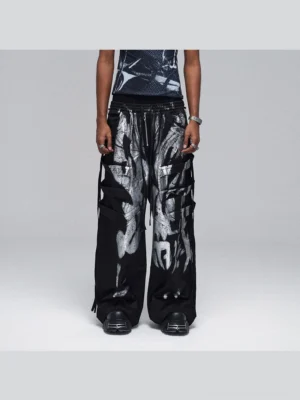 Front view of black metallic strap graffiti cargo pants with silver abstract print, layered utility pockets, and oversized wide-leg streetwear fit