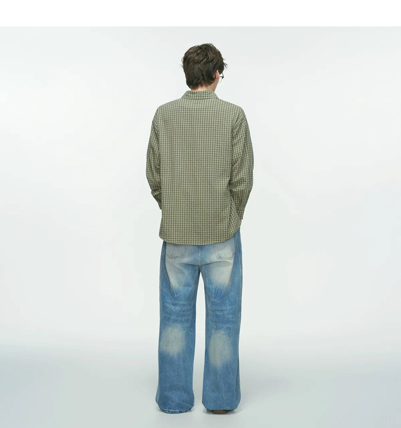 Back view of olive green Metro Grid relaxed fit plaid shirt showing the simple loose silhouette and white grid pattern