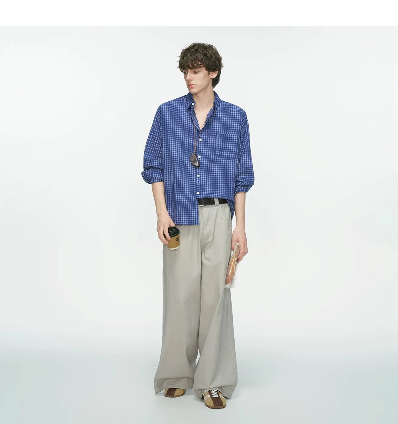 Royal blue and white relaxed fit grid plaid shirt styled with light gray wide-leg trousers and sunglasses for Seoul streetwear