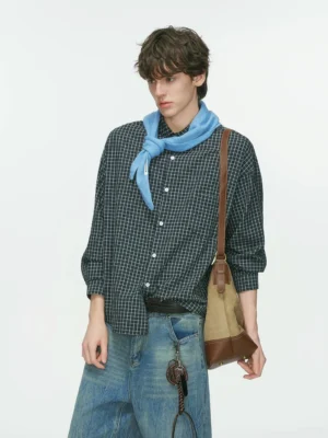 Dark navy Metro Grid relaxed fit plaid shirt with white grid pattern styled with wide-leg blue jeans, blue neck scarf, and shoulder bag