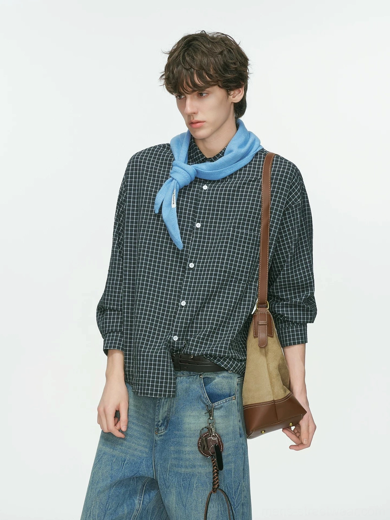 Dark navy Metro Grid relaxed fit plaid shirt with white grid pattern styled with wide-leg blue jeans, blue neck scarf, and shoulder bag