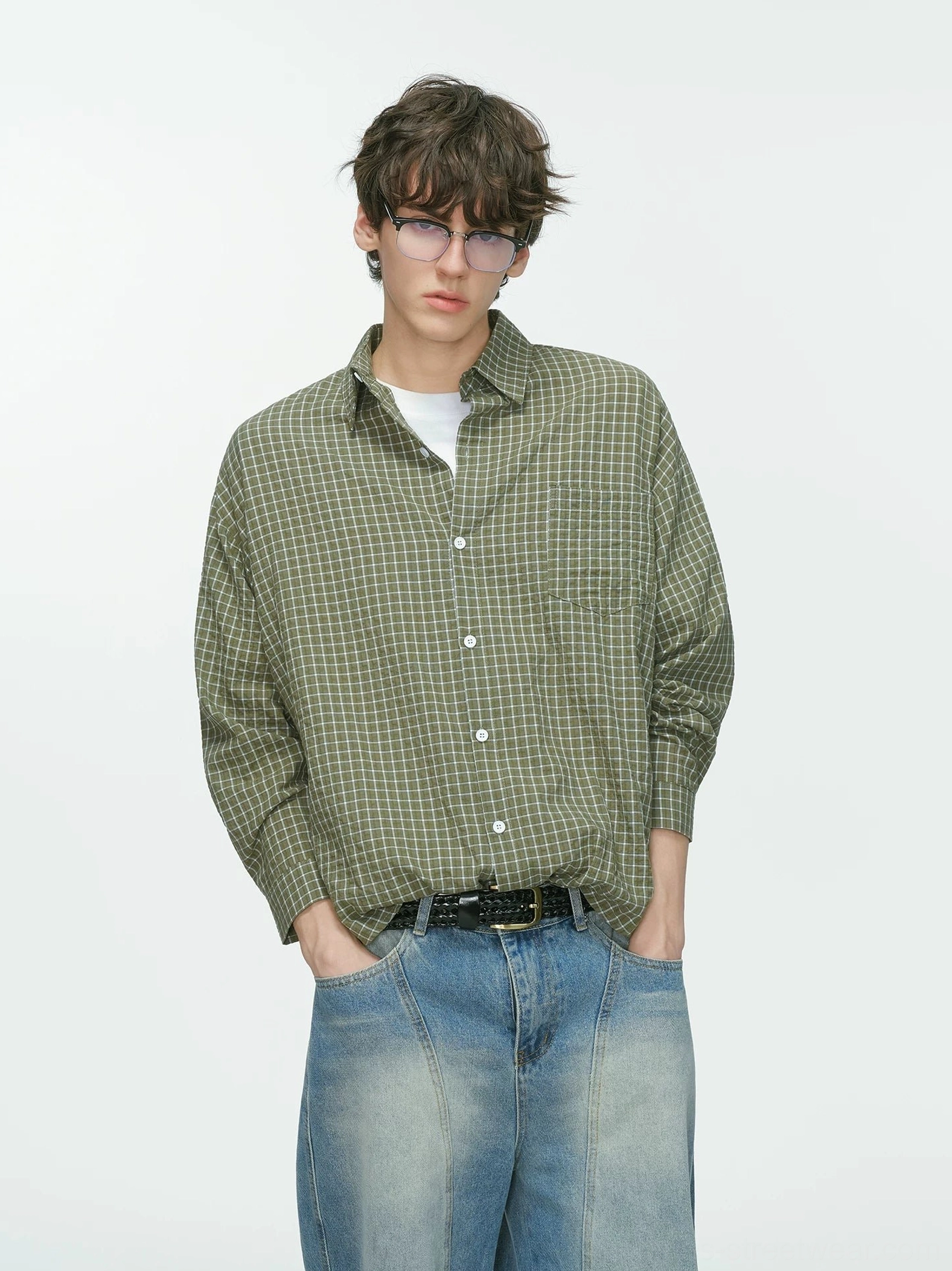 Olive green Metro Grid relaxed fit shirt with white plaid pattern, button-down collar, wide-leg blue jeans, and black leather belt