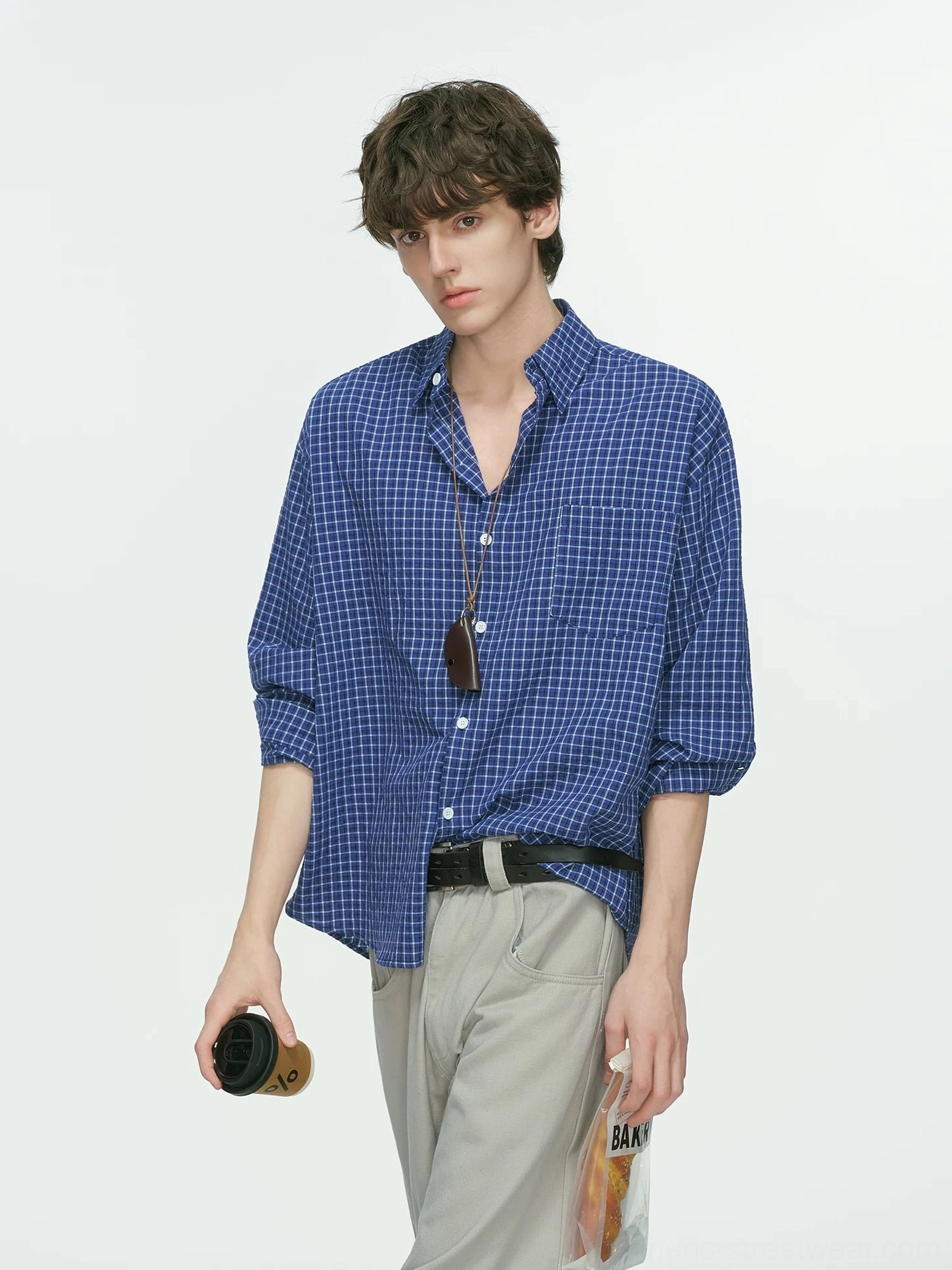 Royal blue and white grid plaid Korean streetwear shirt with relaxed silhouette, rolled sleeves, wide-leg gray trousers, and sunglasses