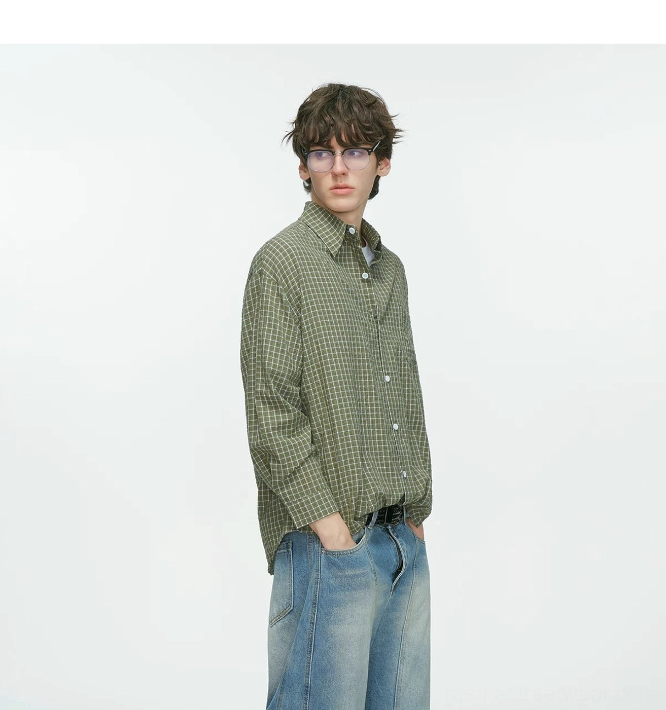 Side view of an olive green relaxed fit plaid grid shirt showing long sleeves, button placket, and loose Korean streetwear silhouette