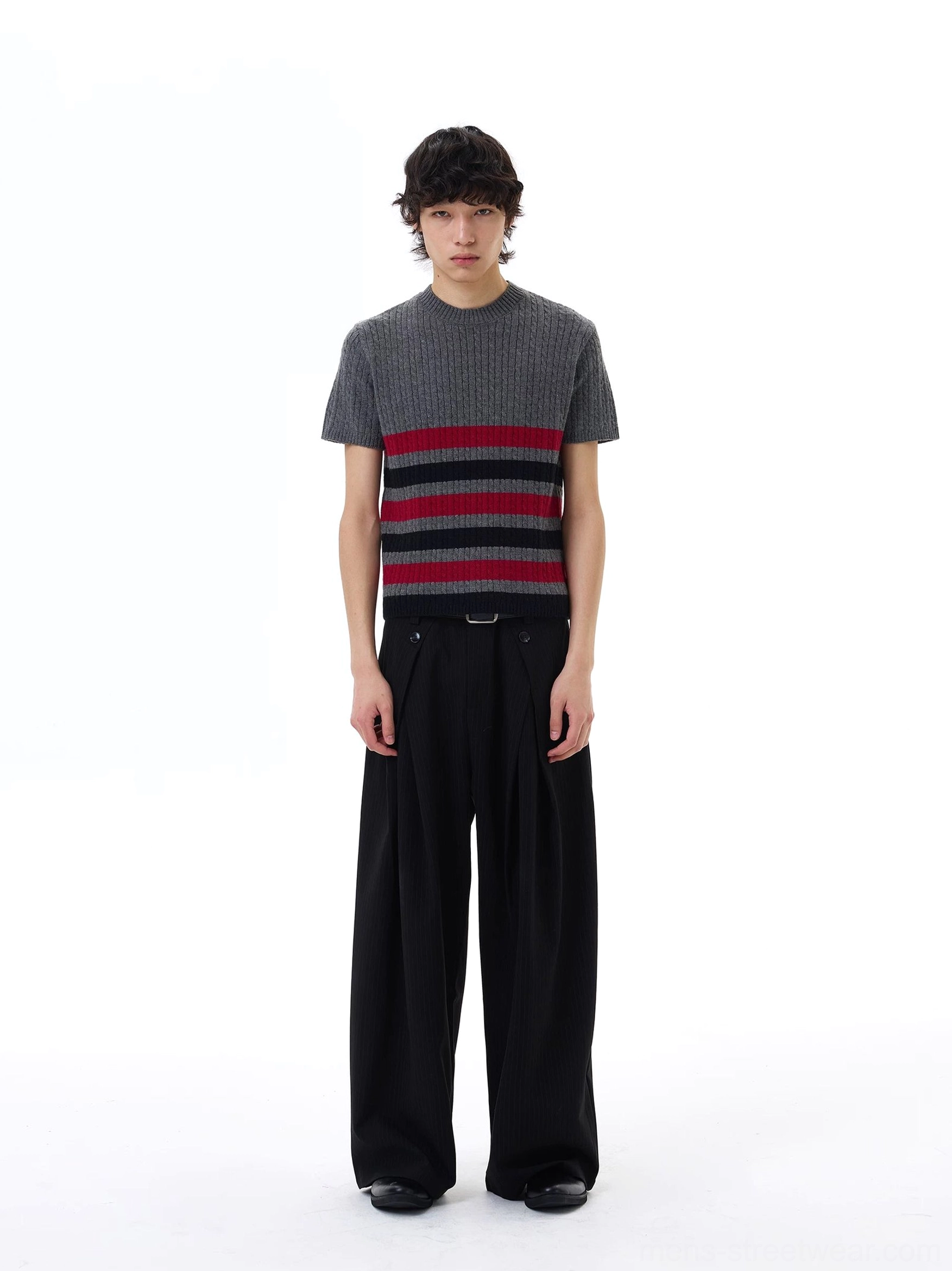 Front studio view of a compact cropped striped ribbed knit tee worn with high-waisted black wide-leg trousers