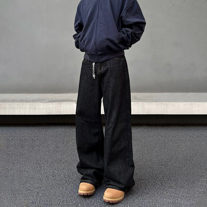 Black washed wide-leg stacked denim jeans for men shown from the back with relaxed loose silhouette and classic rear pockets