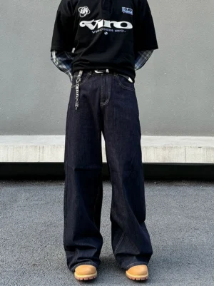 Dark indigo midnight circuit wide-leg stacked denim jeans for men shown from the front with contrast stitching and waist chain detail