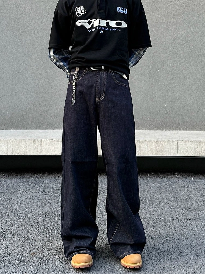 Dark indigo midnight circuit wide-leg stacked denim jeans for men shown from the front with contrast stitching and waist chain detail