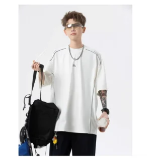 White oversized Korean streetwear tech T-shirt with drop shoulders, reflective-style seam trims, silver necklaces, and relaxed full-body styling