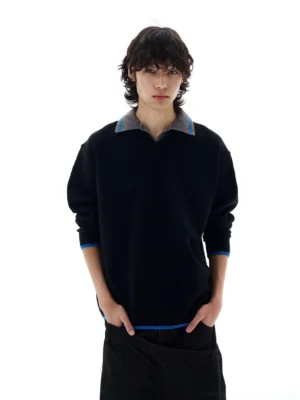 Close front view of men's black relaxed fit polo collar sweater with grey collar and blue contrast trim