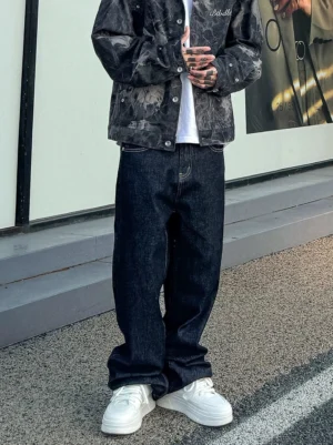 Midnight fade relaxed straight leg jeans in dark indigo denim worn with tie dye jacket on an urban street