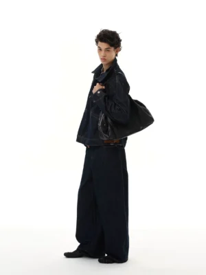 Side view of relaxed midnight indigo zip-up denim jacket with contrast stitching and utility pockets