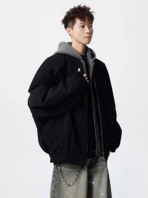 Black oversized layered hooded streetwear bomber jacket with grey hood detail shown in three-quarter front view