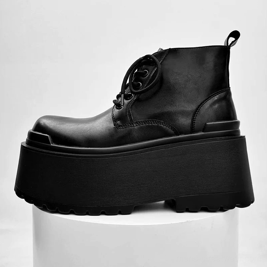 Black lace-up ultra platform ankle boots on white studio pedestal with polished leather upper and monolithic sole