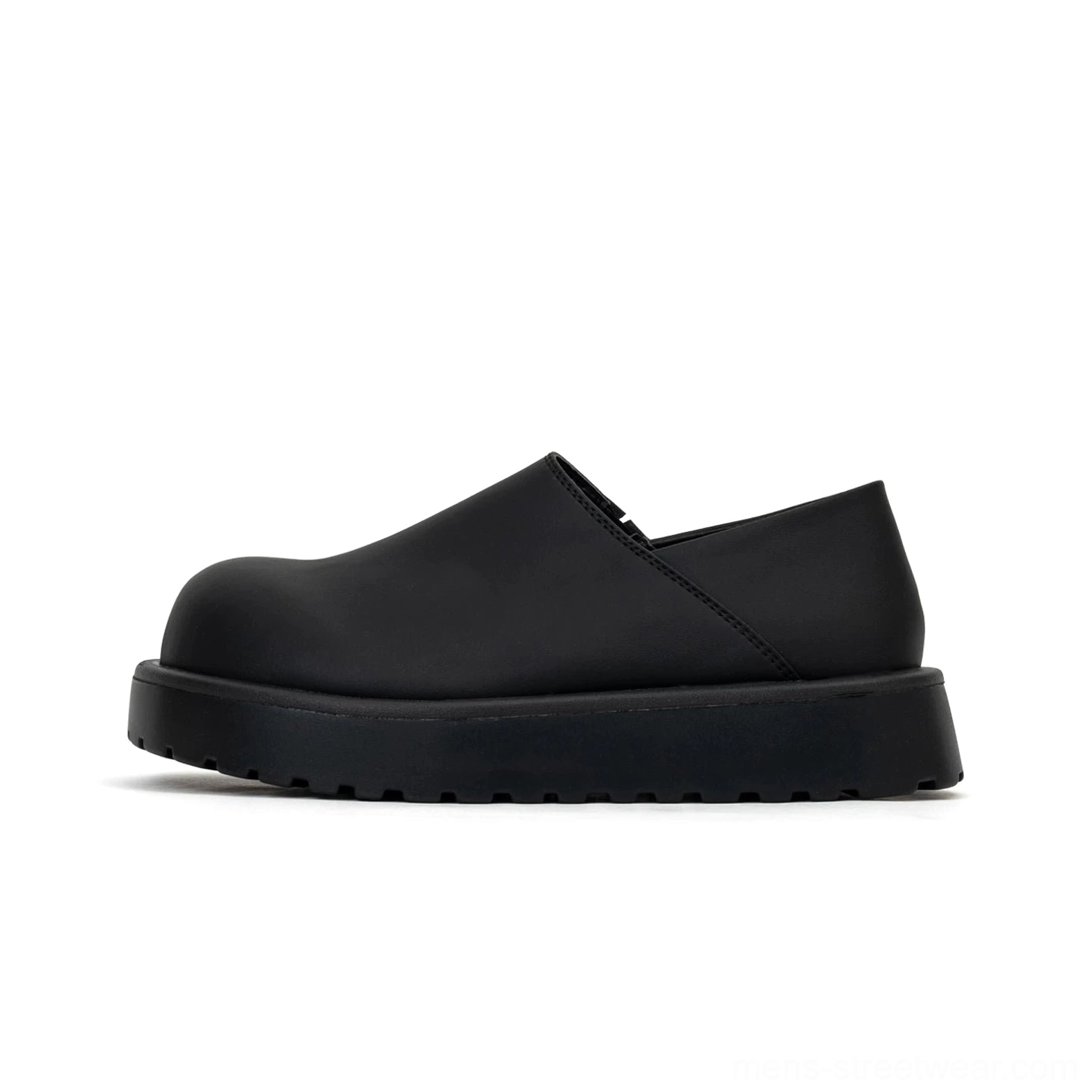 Studio side view of matte black Midnight Monolith platform slip-on clogs with rounded toe and thick treaded rubber sole