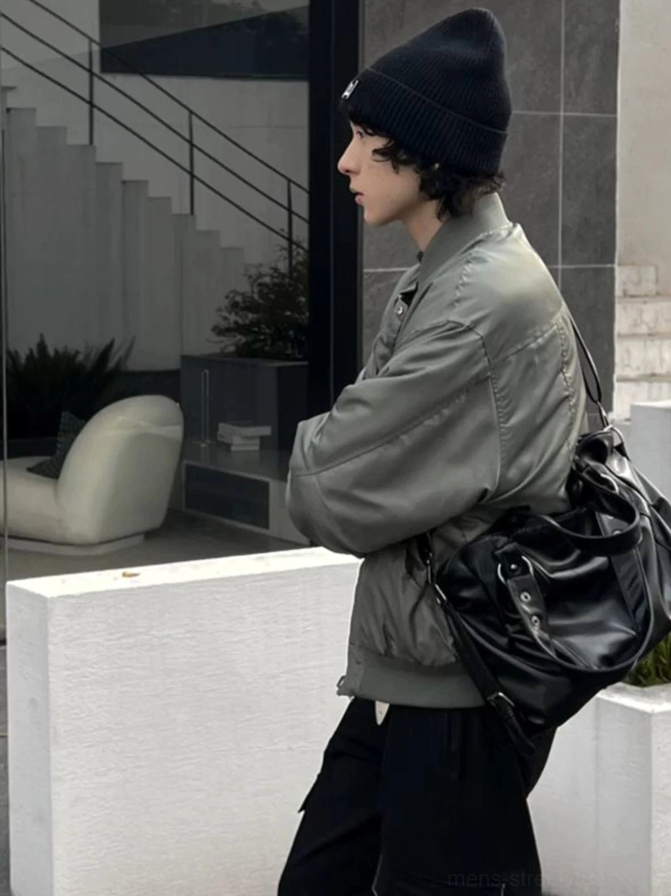 Midnight rivet black faux leather crossbody tote bag side profile in an urban streetwear outfit